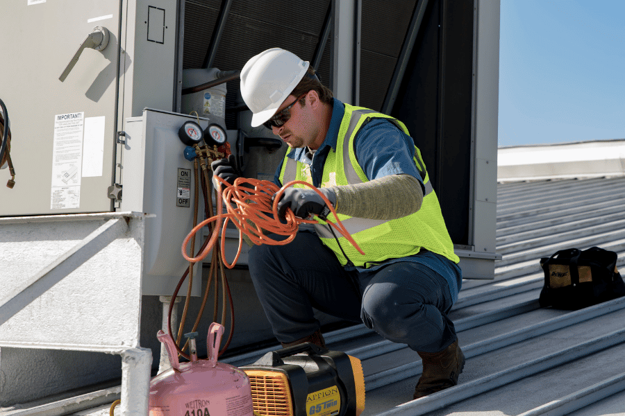 man servicing HVAC unit