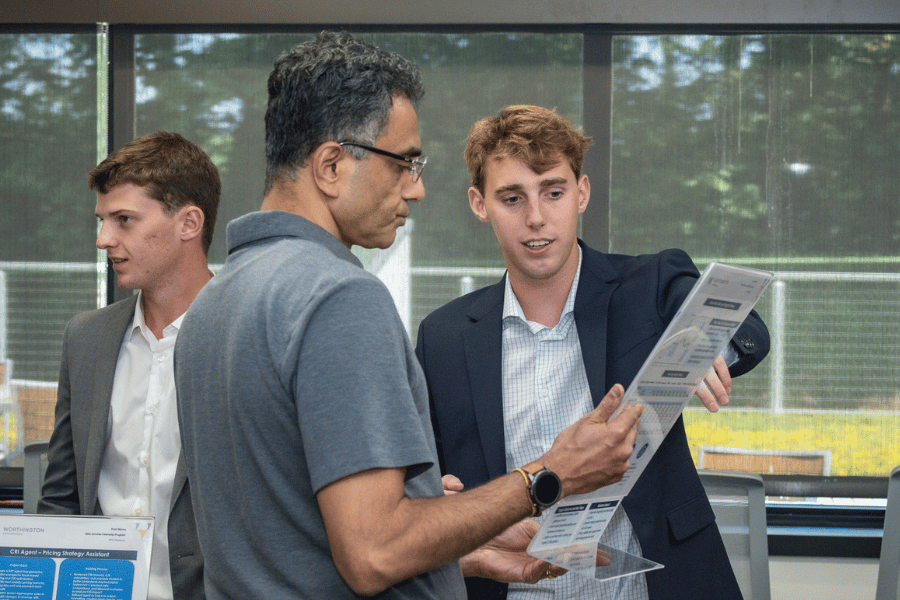Two male employees evaluating information